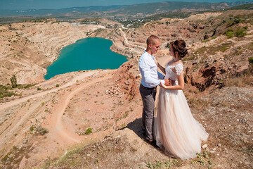 Wedding photosession of young on background a lake in the form of a heart