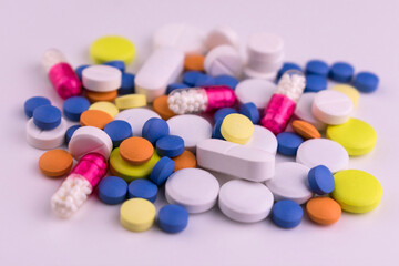 
Lots of colored pills on a white background.Medicine background.