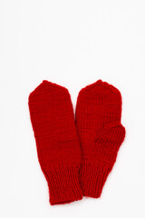 Red knitted winter mittens isolated on white background