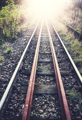Fototapeta na wymiar Facing light on the railroad tracks, color toned picture.