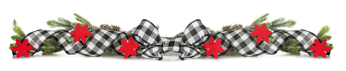 Christmas border of black and white checked buffalo plaid ribbon, red stars and branches isolated on a white background