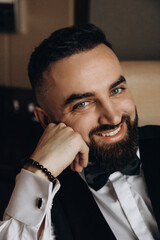 Portrait of the groom. The groom is expecting a meeting with the bride. Photo session of a successful businessman.