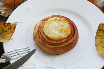 Delicious bun with cottage cheese on a wooden table 