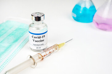 Coronavirus Covid-19 vaccine vial in medical lab, immunization and treatment from coronavirus (Covid-19) medical equipment concept.	
