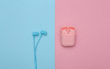 Wireless and wired headphones on a pink-blue pastel background. Top view