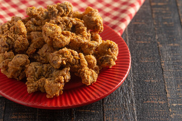 Fried and Crispy Chicken Gizzards on a Dark Wooden Table