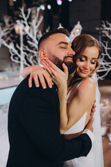 Portrait of the bride and groom. Beautiful decorations. Blue background.
