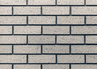 Clean neutral newly laid seamless brick wall.
