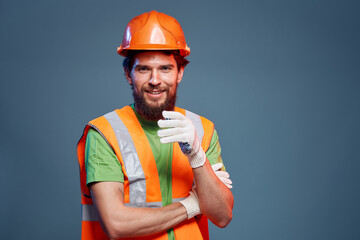 A man in a work uniform is a construction engineer. Industry Professional orange hard hat