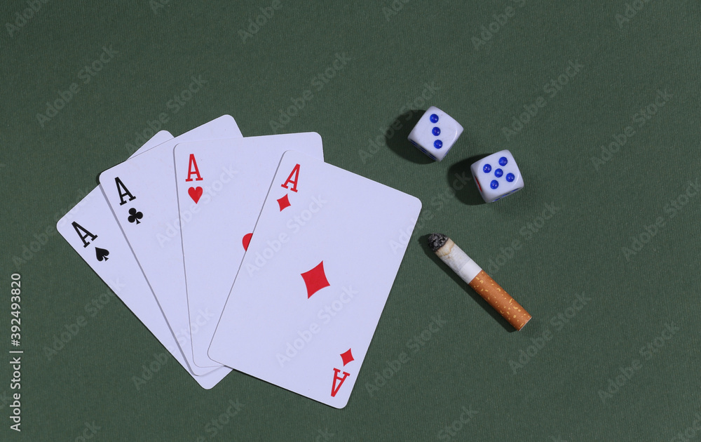 Wall mural gambling and smoking addiction. four aces with dice and cigarette on green background