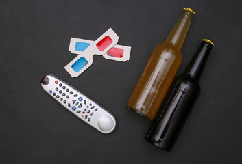 Movie time. Bottle of beer, tv remote, 3d glasses on black background. Top view