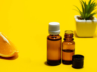 Aromatherapy oils, various bottles with oils on a yellow background. Minimalism. Place for text.