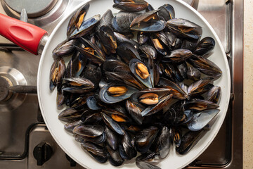 Mussels, open in a pan. Flat lay.