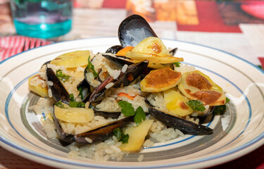 Potato rice mussels. Typical dish from Bari. Southern Italian cuisine. Mediterranean cuisine.