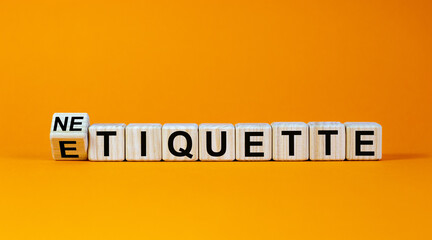 Etiquette or netiquette. Turned cube and changed the word 'etiquette' to 'netiquette'. Beautiful orange background. Business concept. Copy space.
