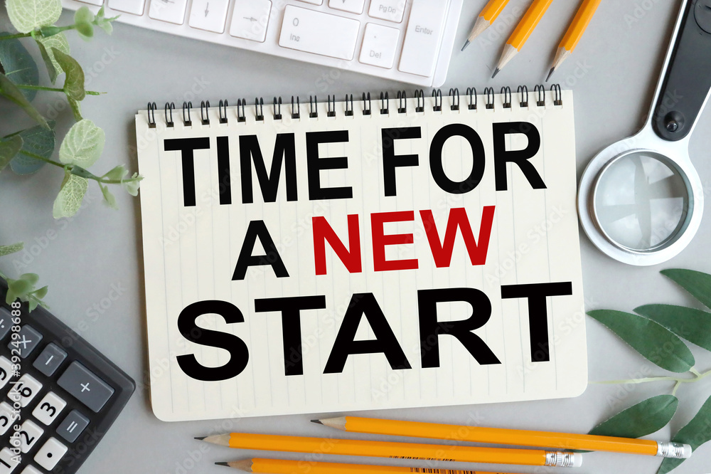 Aufkleber time for new start, text on notebook with gray background