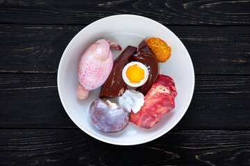 Natural dog food. Bowl of fresh raw organs for dog food. Testicles, liver, kidney, lung, egg and coconut oil. Feed raw.