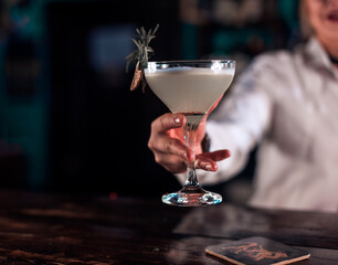 Girl barman creates a cocktail at the beerhouse