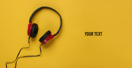 Stylish wired headphones on yellow background. Music lover concept. Copy space