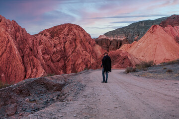 Man walking down desert road