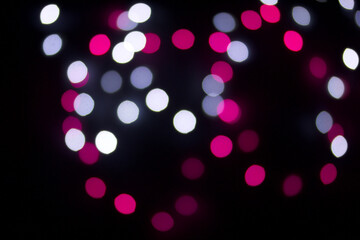 A blur of colored lights. Burning garlands on a dark background.