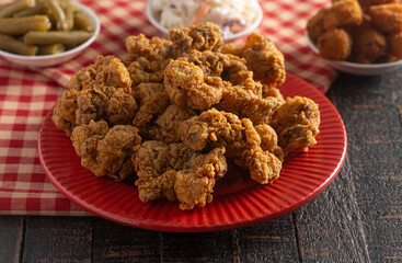 Fried and Crispy Chicken Gizzards on a Dark Wooden Table