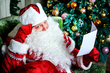 Portrait of Santa Claus reading Christmas letters