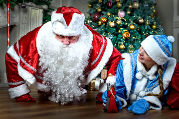 New year and Christmas greetings. Funny snow maiden and Santa Claus. Russian holiday.