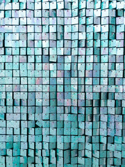 Vertical image of square blue sequined fabric texture - shiny green sparkling sequins background....