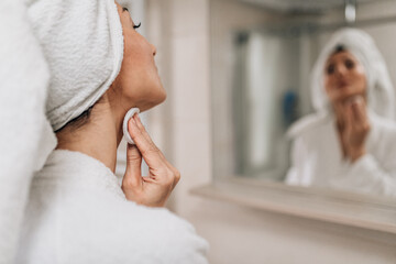 Beautiful middle age woman morning or evening bathroom routine. Modern lifestyle concept.
