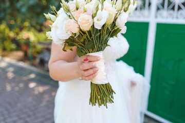 bride holding bouquet and lipstick