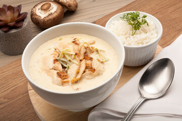 Creamy chicken mushroom soup, easy chicken soup recipe with optional cream of mushroom soup and herbs in a white bowl.