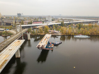 Aerial drone view. Bridge construction site in Kiev. Cloudy autumn morning.