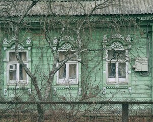 Old rural wooden house in a russian village. Russian traditional national folk style in wooden architecture.
