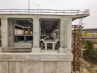 Aerial drone view. The edge of an unfinished bridge in Kiev. Cloudy autumn morning.