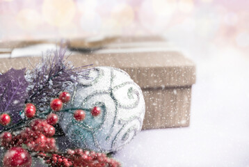 Christmas composition. Gift, for tree branches, white balls decorations on bokeh background.