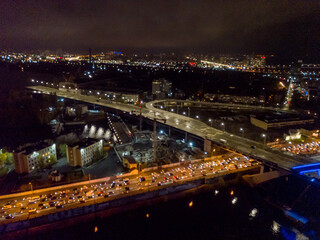 Fototapeta na wymiar Aerial drone view. Bridge construction site in Kiev in the evening.