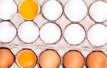 Many eggs lie on the background of hay, top view.
