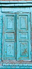 Wooden blue shutters. Closed window. Vintage window.