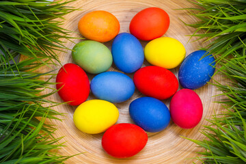 Fototapeta na wymiar colorful eggs, easter eggs in a bowl, easter eggs in the grass