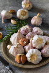 Healthy food. Garlic Cloves and Bulb on a stone or slate table.