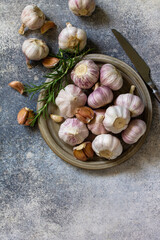 Healthy food. Garlic Cloves and Bulb on a stone or slate table. Top view flat lay background. Copy space.