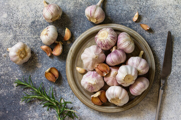 Healthy food. Garlic Cloves and Bulb on a stone or slate table. Top view flat lay background.