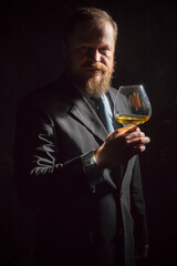 Solid confident bearded man in suit with glass of whisky