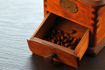 Old coffee grinder and coffee beans