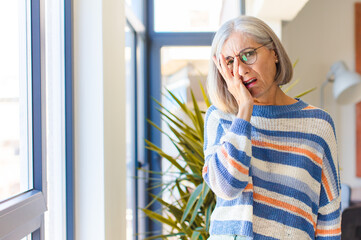 middle age woman feeling bored, frustrated and sleepy after a tiresome, dull and tedious task,...