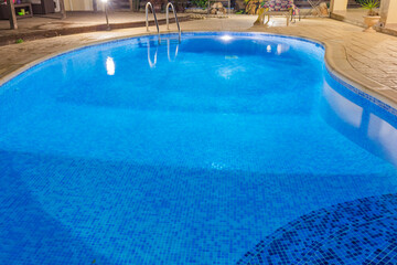 Blue water swimming pool close up view.