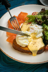 English breakfast, toast, poached egg, sauce, salmon
