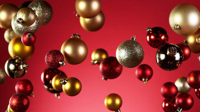 Flying christmas balls on coloured background