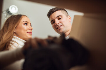 Couple unpacking box at new home